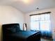 Comfortable bedroom with a tufted headboard, soft pillows, and a window with natural light at 1980 Beyers Landing Dr, Buford, GA 30519