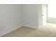 Empty bedroom with neutral carpeting, white walls, and a door to the closet at 1980 Beyers Landing Dr, Buford, GA 30519