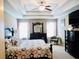 Relaxing main bedroom boasts a tray ceiling, ceiling fan, and furniture at 1980 Beyers Landing Dr, Buford, GA 30519