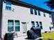 Back exterior of home with multiple windows, glass door, and lush green lawn at 1980 Beyers Landing Dr, Buford, GA 30519