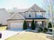 Beautiful two-story home boasts stone accents and a well-maintained front yard at 1980 Beyers Landing Dr, Buford, GA 30519
