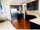 Spacious kitchen with stainless steel appliances, granite countertops, and dark wood cabinetry at 1980 Beyers Landing Dr, Buford, GA 30519