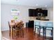 A modern eat-in kitchen features a wooden table with blue chairs and a breakfast bar at 1980 Beyers Landing Dr, Buford, GA 30519