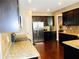 Well-appointed kitchen features granite countertops, dark cabinets, and stainless steel appliances at 1980 Beyers Landing Dr, Buford, GA 30519