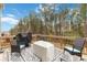 Outdoor deck featuring wicker seating, a grill, and wooded views, perfect for entertaining at 3478 Spring Place Ct, Loganville, GA 30052