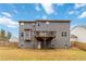 Back exterior of a gray home with a deck overlooking a large grassy backyard at 3478 Spring Place Ct, Loganville, GA 30052