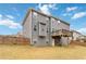 Exterior view of a home with gray siding, a small deck, and a spacious backyard at 3478 Spring Place Ct, Loganville, GA 30052