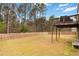 Expansive fenced backyard with mature trees and an inviting wooden deck area at 3478 Spring Place Ct, Loganville, GA 30052