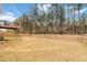 Spacious backyard featuring a wooden fence and ample greenery with tall trees behind at 3478 Spring Place Ct, Loganville, GA 30052