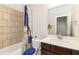 Clean bathroom featuring tile accents, vanity with a mirror, and shower with curtain at 3478 Spring Place Ct, Loganville, GA 30052