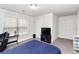 A bright bedroom features neutral walls, a comfortable desk, and a large window at 3478 Spring Place Ct, Loganville, GA 30052
