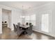 Dining room with modern table and chairs, natural light, and hardwood flooring at 3478 Spring Place Ct, Loganville, GA 30052