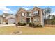 Beautiful two-story home with a two-car garage, landscaped front yard with trees and a well-maintained lawn at 3478 Spring Place Ct, Loganville, GA 30052