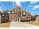 Attractive two-story brick home boasting a two-car garage, lush green lawn, and well-maintained landscaping at 3478 Spring Place Ct, Loganville, GA 30052