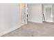 Bright hallway with neutral carpet, offering seamless transition between rooms at 3478 Spring Place Ct, Loganville, GA 30052