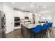 Modern kitchen features stainless appliances, a center island with counter seating, and pendant lighting at 3478 Spring Place Ct, Loganville, GA 30052