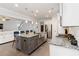 This kitchen has a large island with bar stool seating, stainless appliances, and granite countertops at 3478 Spring Place Ct, Loganville, GA 30052