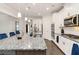 Bright kitchen features stainless appliances, granite counters, modern cabinets, and pendant lighting at 3478 Spring Place Ct, Loganville, GA 30052