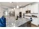 Gourmet kitchen features stainless steel appliances, granite counters, and a large center island at 3478 Spring Place Ct, Loganville, GA 30052