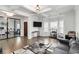 Elegant living room featuring coffered ceilings, a modern sofa, and a view of the adjacent office space at 3478 Spring Place Ct, Loganville, GA 30052
