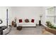 Bright living room featuring plush sofa with pillows, lamps, and exercise bike at 3478 Spring Place Ct, Loganville, GA 30052