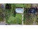 Aerial view of renovated home's new roof, spacious yard and surroundings with mature trees at 3762 Larkspur Ter, Decatur, GA 30032