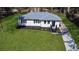 Aerial view of a newly renovated single-story home with a well-manicured lawn and private driveway at 3762 Larkspur Ter, Decatur, GA 30032