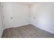 An empty bedroom with grey laminate floors, white walls, and white trim and doors at 3762 Larkspur Ter, Decatur, GA 30032