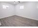 This empty bedroom features hardwood-style floors, recessed lighting, and bright windows at 3762 Larkspur Ter, Decatur, GA 30032