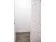 View into closet with neutral walls and gray wood-look laminate flooring with white trim and a door at 3762 Larkspur Ter, Decatur, GA 30032