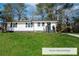 Charming renovated single-story home featuring black trim, front lawn, and beautiful landscaping at 3762 Larkspur Ter, Decatur, GA 30032