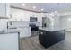 This modern kitchen is equipped with stainless steel appliances, granite counters, a herringbone backsplash, and a kitchen island at 3762 Larkspur Ter, Decatur, GA 30032