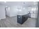Open concept kitchen with stainless steel appliances, granite counters, white cabinets, and an island at 3762 Larkspur Ter, Decatur, GA 30032