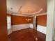 Elegant dining room featuring dark hardwood floors, rust colored walls, wainscotting, and stylish chandelier at 3963 Lucas Ln, Ellenwood, GA 30294