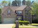 Charming two-story brick home with a well-manicured lawn and attached two-car garage at 3963 Lucas Ln, Ellenwood, GA 30294