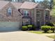 Charming two-story brick home with a well-manicured lawn and attached two-car garage at 3963 Lucas Ln, Ellenwood, GA 30294