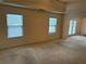 Spacious main bedroom with large windows, plush carpet, and ensuite bath access at 3963 Lucas Ln, Ellenwood, GA 30294