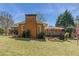 Brick home featuring a deck, patio, and spacious backyard with lush greenery at 4162 Brownlee Dr, Tucker, GA 30084