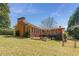Brick home with a large yard, deck, and a well-maintained lawn at 4162 Brownlee Dr, Tucker, GA 30084