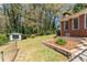 Spacious backyard with brick home, storage shed, and manicured landscaping at 4162 Brownlee Dr, Tucker, GA 30084