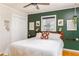 Stylish bedroom featuring a queen bed, hardwood floors, and designer-painted accent wall at 4162 Brownlee Dr, Tucker, GA 30084