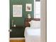 Serene bedroom with dark green walls, a wooden headboard, and minimalist decor at 4162 Brownlee Dr, Tucker, GA 30084