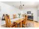 Charming dining room with a rustic wooden table, rug, and modern geometric light fixture at 4162 Brownlee Dr, Tucker, GA 30084
