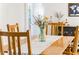 Bright dining room with natural wood table, chairs, and flowers at 4162 Brownlee Dr, Tucker, GA 30084