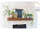 Stone fireplace mantel decorated with plants and artwork at 4162 Brownlee Dr, Tucker, GA 30084