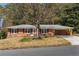 Charming brick home featuring a well-manicured front yard and a cozy, covered carport at 4162 Brownlee Dr, Tucker, GA 30084