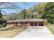 Charming single story brick home with a long driveway, carport, and well-maintained lawn at 4162 Brownlee Dr, Tucker, GA 30084