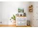 Cozy kitchen area with a white rolling island, decorative plant, and floating wooden shelves at 4162 Brownlee Dr, Tucker, GA 30084