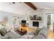 Bright and airy living room with stone fireplace and wood floors at 4162 Brownlee Dr, Tucker, GA 30084