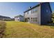 Backyard featuring a spacious lawn and view of the neighborhood, perfect for outdoor activities and relaxation at 417 Flowery Branch Ct, Villa Rica, GA 30180